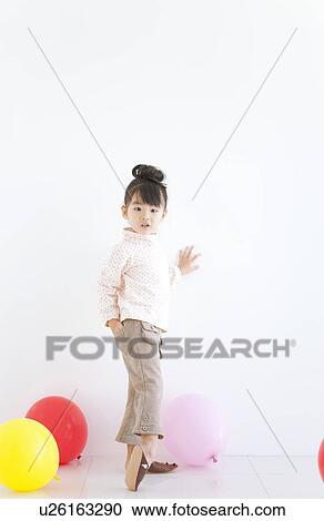 Portrait of girl playing with balloons, looking back, white background View Large Photo Image Stock Image - Portrait of girl playing with balloons, looking back, white background. Fotosearch