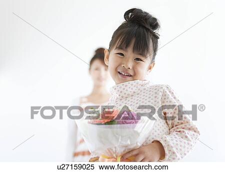Portrait of girl with mother holding flower bouquet, white background, differential focus View Large Photo Image Stock Photography - Portrait of girl with mother holding flower bouquet, white background, differential focus. Fotosearch