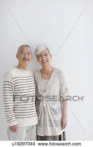 Portrait of mature couple, smiling, white background View Large Photo Image Picture - Portrait of mature couple, smiling, white background. Fotosearch