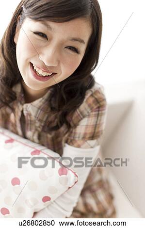 Stock Image - Portrait of young woman, smiling. Fotosearch
