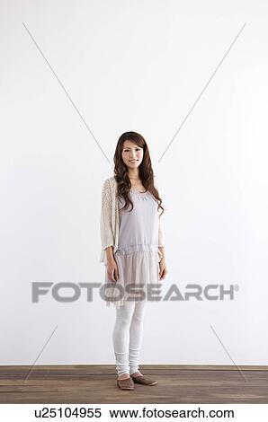 Stock Photography - Portrait of young woman, smiling, white background. Fotosearch