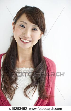 Stock Image - Portrait of young woman, white background. Fotosearch