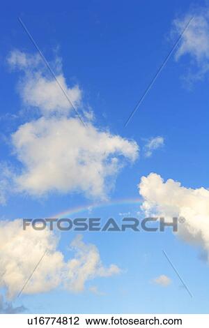 Stock Image - Rainbow in Blue Sky, Hawaii, USA. Fotosearch