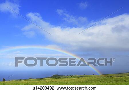 Stock Image - Rainbow Over Field, Hawaii, USA. Fotosearch