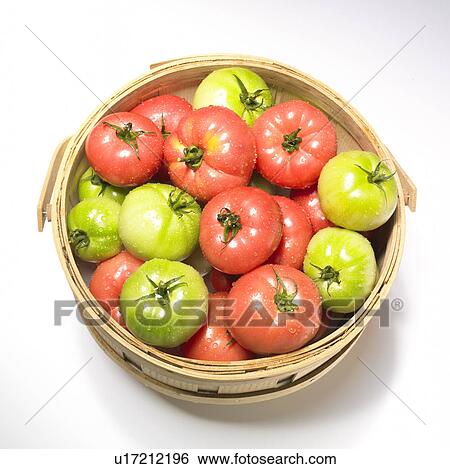 Stock Photograph - Red and green tomatoes in basket, white background. Fotosearch