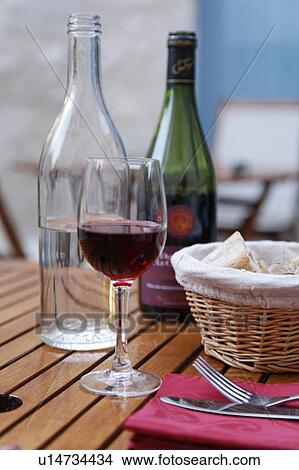 Picture - Red wine bottle and glass. Fotosearch