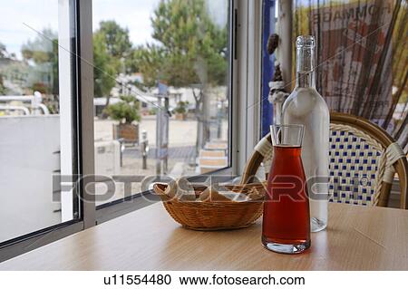Stock Image - Red Wine in Decanter on Table. Fotosearch