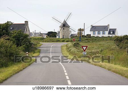 Stock Photo - Road in the Center, Houses and Windmill in the Background, Finistere, Bretagne, France. Fotosearch