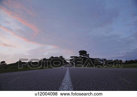Road Under the Sunset Sky, Bretagne, France View Large Photo Image Stock Photo - Road Under the Sunset Sky, Bretagne, France. Fotosearch