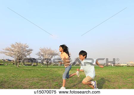 Stock Photography - Siblings running. Fotosearch