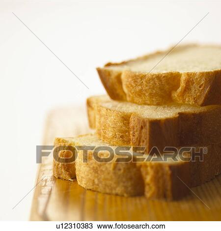 Stock Image - Sliced bread on cutting board. Fotosearch