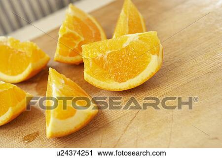 Sliced oranges on cutting board, close up View Large Photo Image Stock Image - Sliced oranges on cutting board, close up. Fotosearch