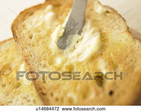 Stock Image - Slices of toast with butter, close up. Fotosearch