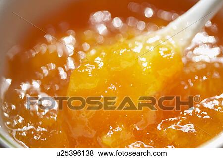 Spoon scooping apricot jam, close up View Large Photo Image Stock Photo - Spoon scooping apricot jam, close up. Fotosearch