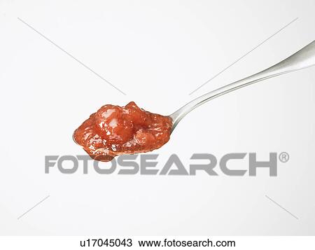 Stock Image - Strawberry jam on spoon, white background. Fotosearch