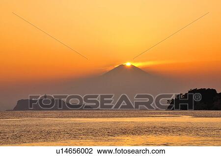 Stock Image - Sun above Mt. Fuji . Fotosearch