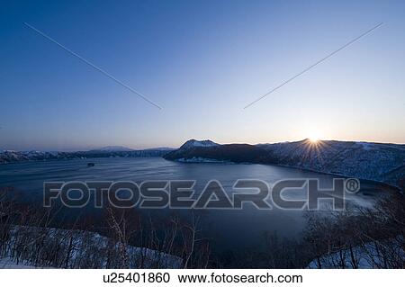 Stock Image - Sunrise and Lake Mashu. Fotosearch