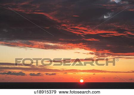 Stock Photo - Sunset at sea. Fotosearch