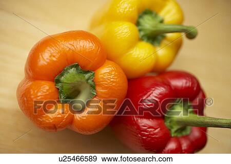 Stock Photo - Three bell peppers, close up. Fotosearch