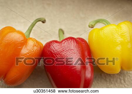 Stock Photo - Three bell peppers, close up. Fotosearch