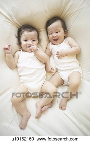 Stock Image - Twin babies laying. Fotosearch