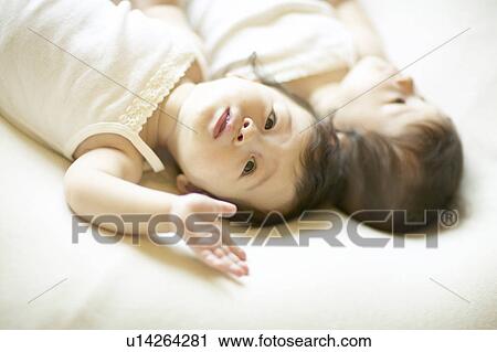 Stock Image - Twin babies lying. Fotosearch