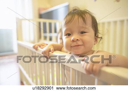 Stock Image - Twin babies on the bed. Fotosearch