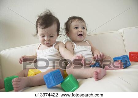 Twin babies playing with blocks View Large Photo Image Stock Image - Twin babies playing with blocks. Fotosearch