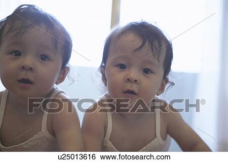 Stock Photograph - Twin babies. Fotosearch