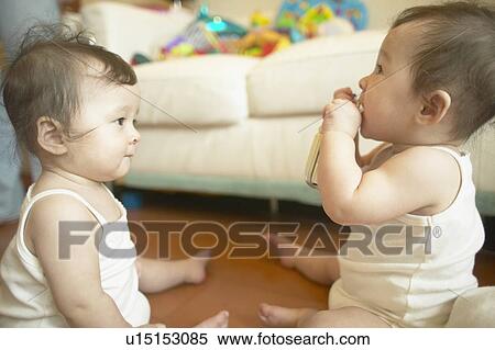 Twin baby girls playing View Large Photo Image Stock Photography - Twin baby girls playing. Fotosearch