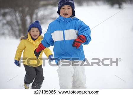 Two boys playing in snow View Large Photo Image Stock Photograph - Two boys playing in snow. Fotosearch