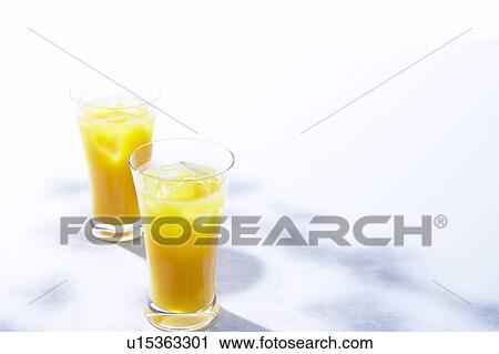 Two glasses of orange juice View Large Photo Image Stock Image - Two glasses of orange juice. Fotosearch