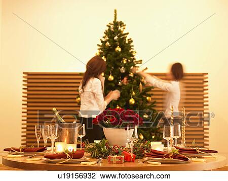 Two women decorating Christmas tree, blurred motion View Large Photo Image Stock Image - Two women decorating Christmas tree, blurred motion. Fotosearch