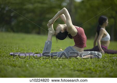 Stock Image - Two Young Stretching. Fotosearch