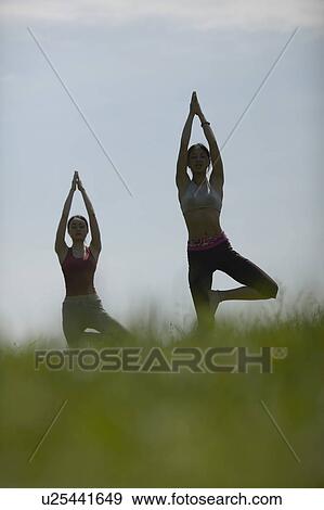 Two Young Women Doing A Stretching Exercise View Large Photo Image Stock Photo - Two Young Women Doing A Stretching Exercise. Fotosearch