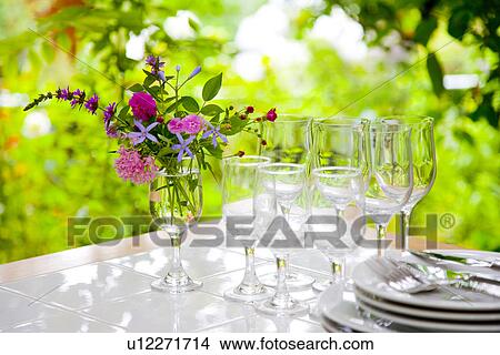 Picture - Vase of flowers and tableware on table. Fotosearch