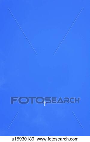 Stock Photo - White Airplane Flying in Blue Sky, Hawaii, USA. Fotosearch