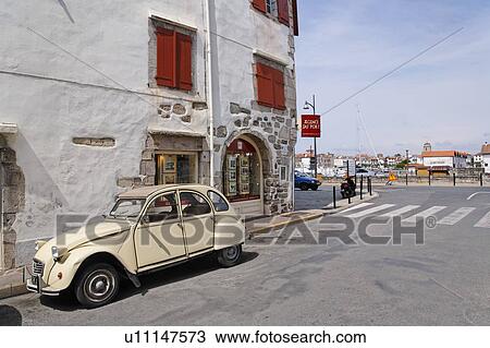 Stock Image - White Car Parked on Street, Pyrenees At Lantiques, France. Fotosearch