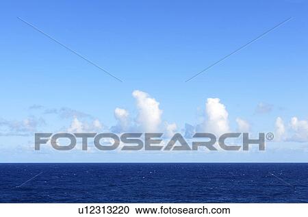 Stock Image - White Clouds Over Blue Sea, Hawaii, USA. Fotosearch