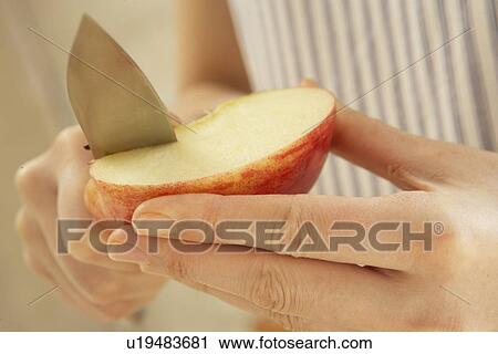 Woman cutting apple, close up View Large Photo Image Stock Image - Woman cutting apple, close up. Fotosearch