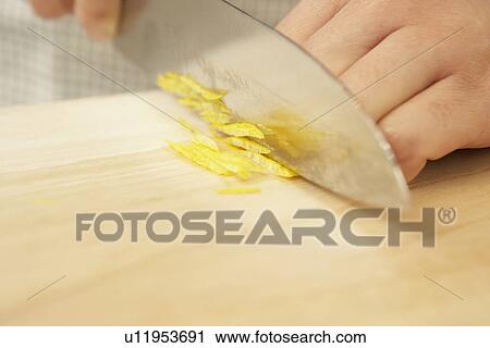 Woman cutting yuzu fruit on cutting board, close up View Large Photo Image Stock Image - Woman cutting yuzu fruit on cutting board, close up. Fotosearch