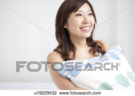 Stock Image - Woman holding a pillow. Fotosearch