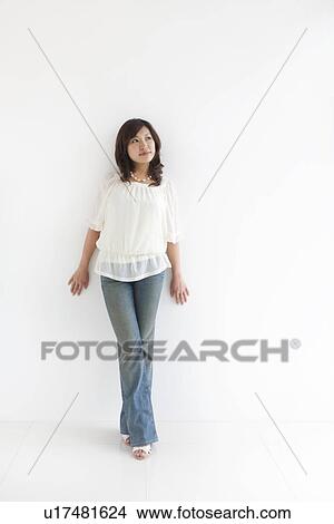 Picture - Woman leaning on wall. Fotosearch