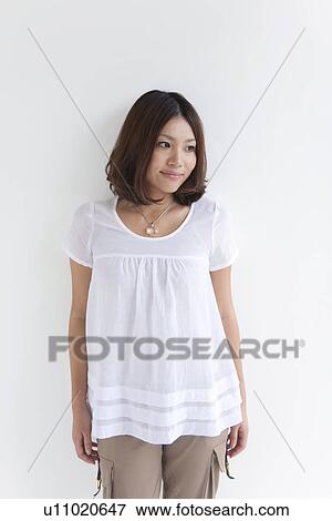 Woman leaning on wall View Large Photo Image Stock Photo - Woman leaning on wall. Fotosearch