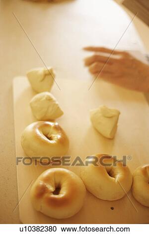 Stock Image - Woman making bagels, close up. Fotosearch