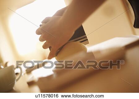 Woman making bagels, cutting dough, close up View Large Photo Image Stock Photograph - Woman making bagels, cutting dough, close up. Fotosearch