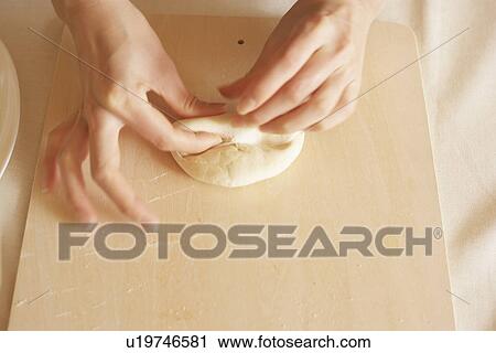Woman making bagels, rolling dough, close up View Large Photo Image Stock Image - Woman making bagels, rolling dough, close up. Fotosearch