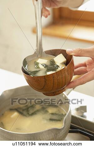 Picture - Woman making Miso soup, close up. Fotosearch