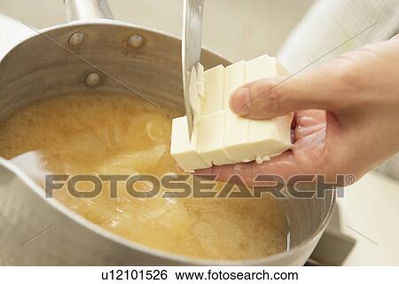 Stock Photograph - Woman making Miso soup, close up. Fotosearch