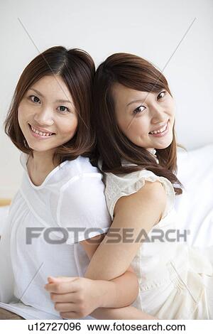 Women looking at camera smiling View Large Photo Image Stock Photograph - Women looking at camera smiling. Fotosearch